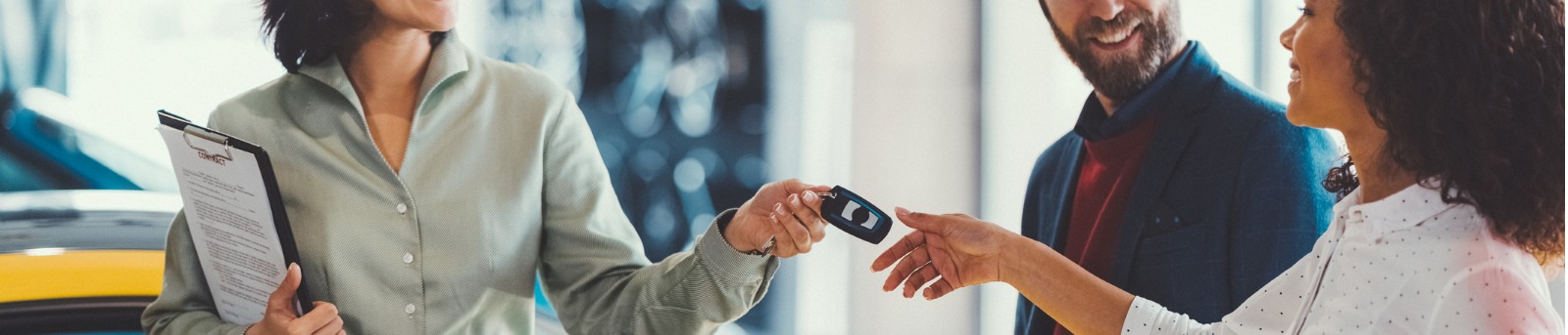 Man and woman receiving brand new car keys