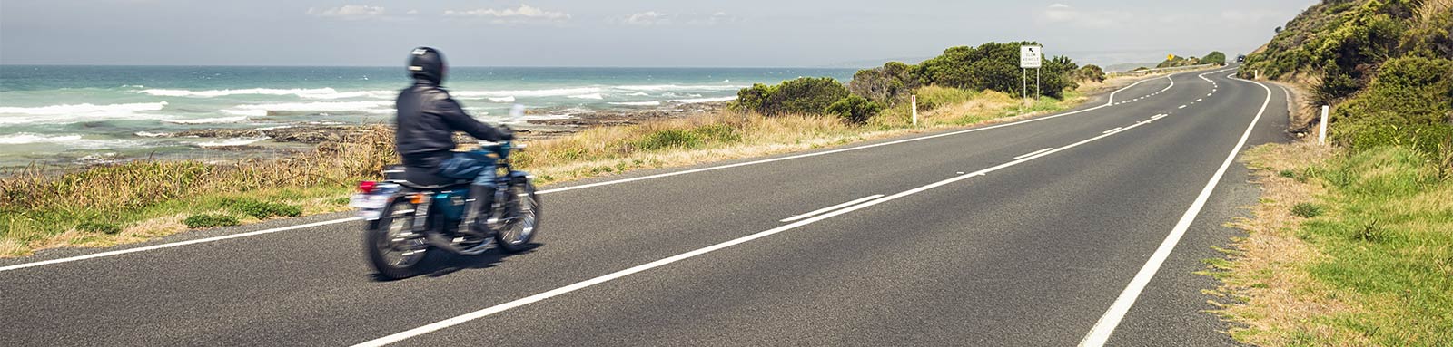 Motorcyclist on a coastal road