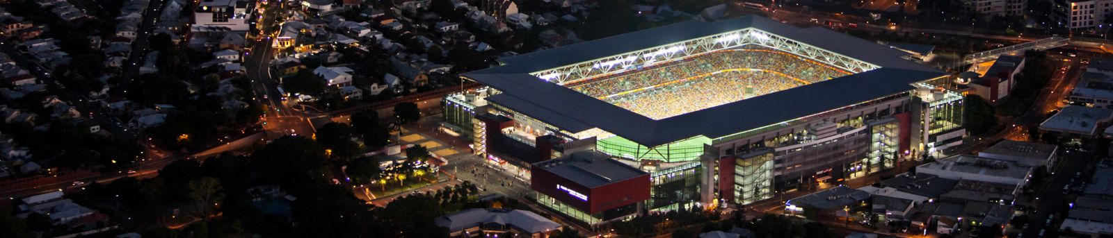 Birdeye view of suncorp stadium at night with surrounding suburbs