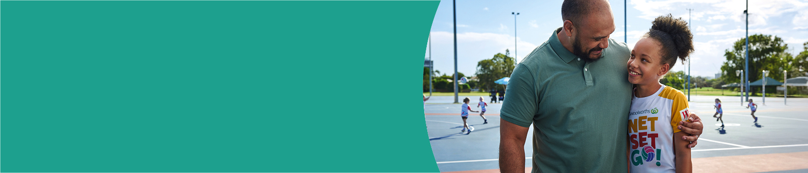 Father hugs daughter at netball courts