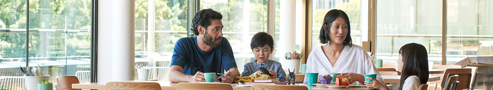 A family of four at cafe table