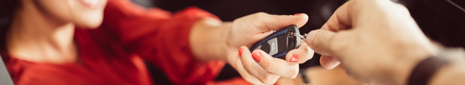 Woman in red a holding a car key