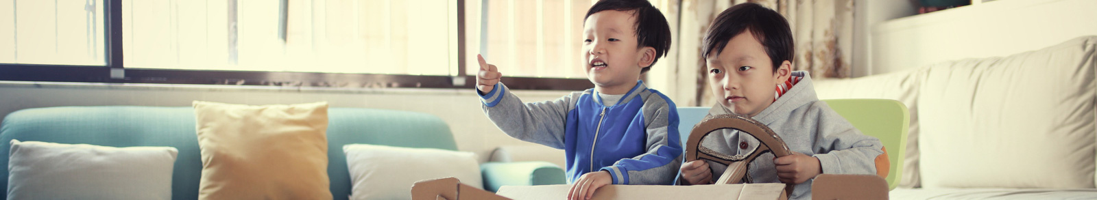 Two boys playing in a toy car