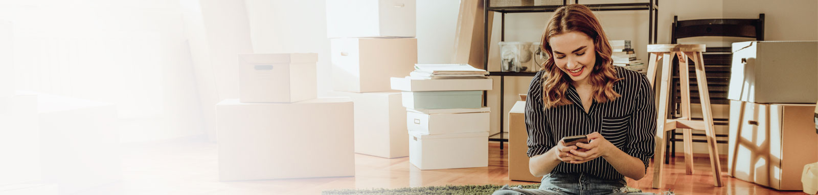 WOman moving to a new apartment with boxes