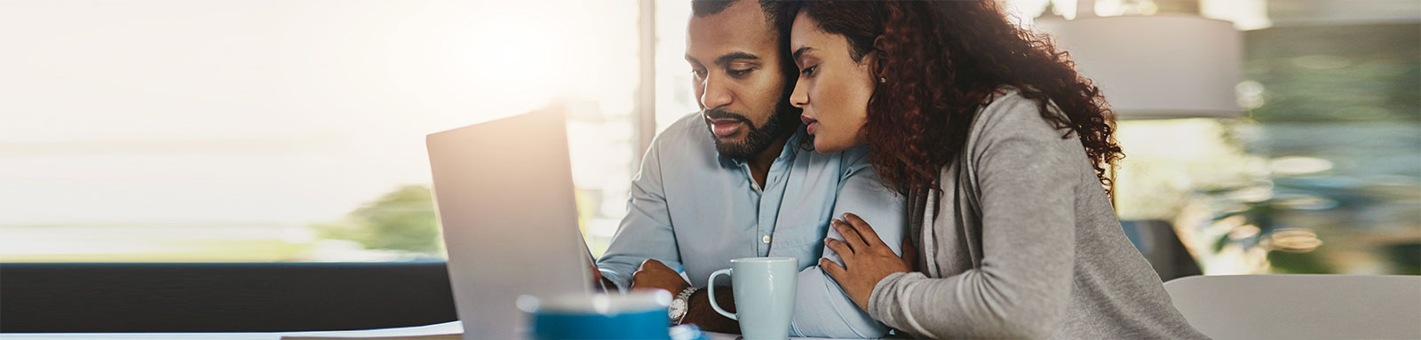 Couple looking at laptop on a table