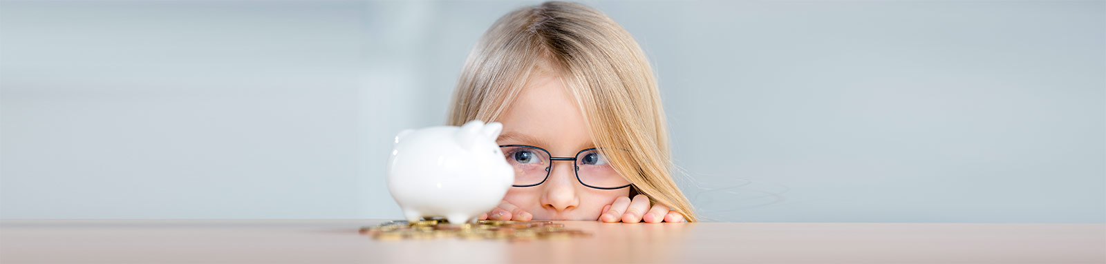 Girl looking at a piggy bank