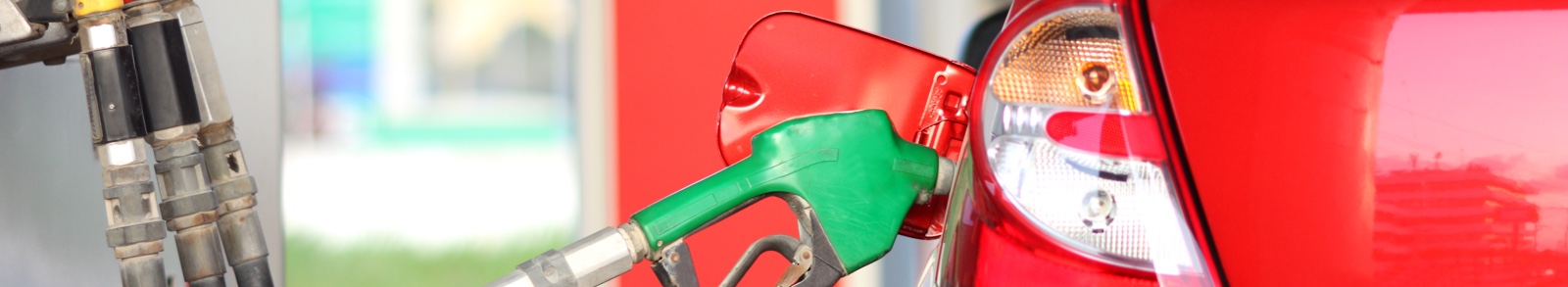 Green petrol pump inside a red car