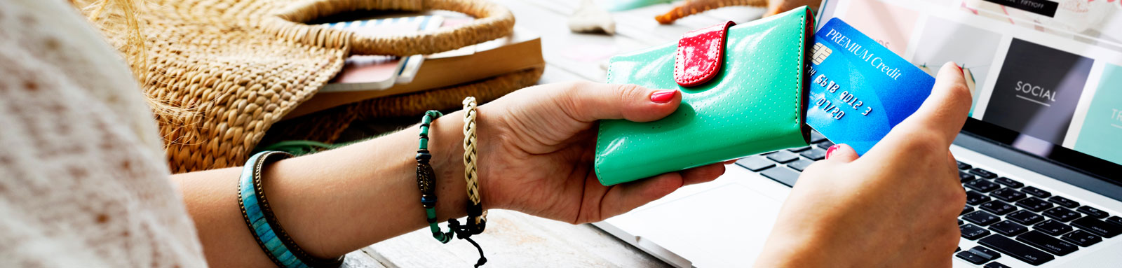 Woman holding a green wallet and credit card for online shopping