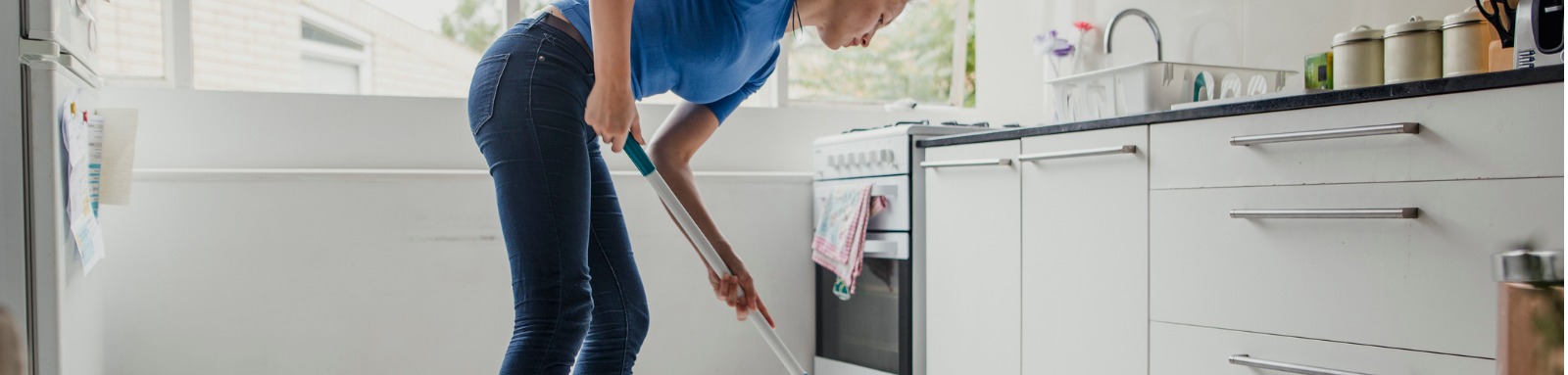 Woman mopping kitchen floor 