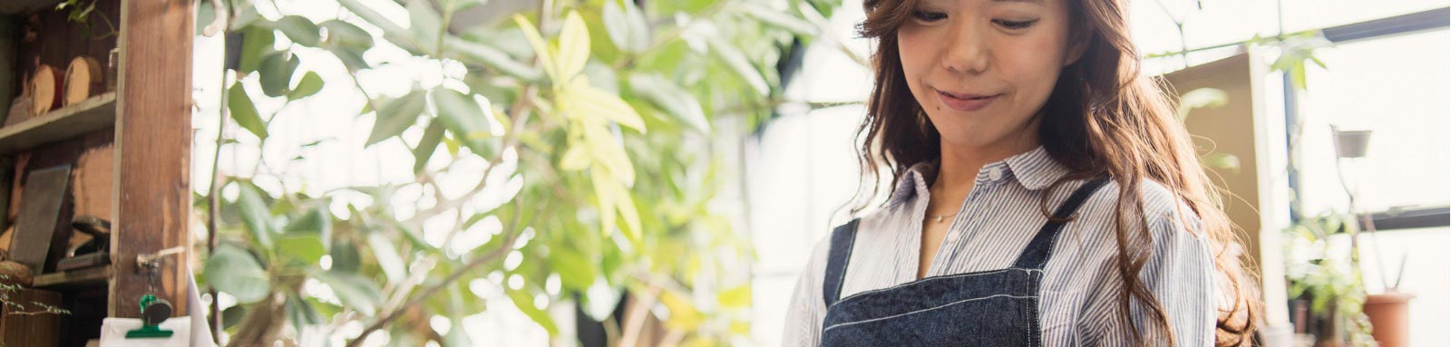 Woman in plant shop looking at tablet