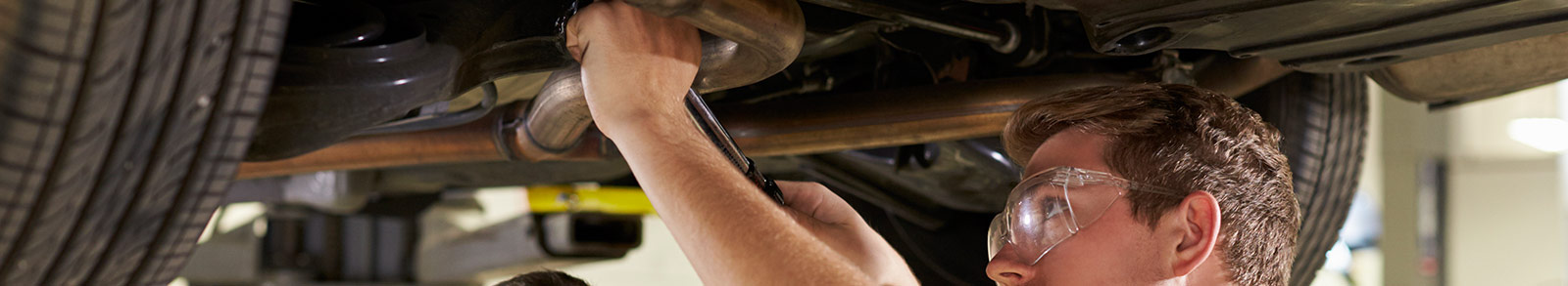 Mechanic working under a car