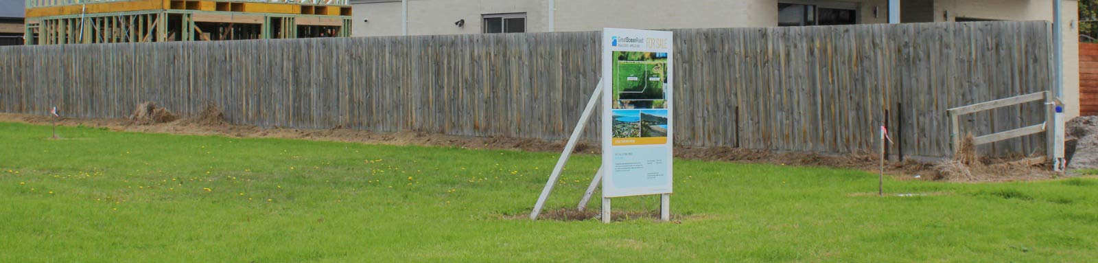 Empty block of land with nearby houses