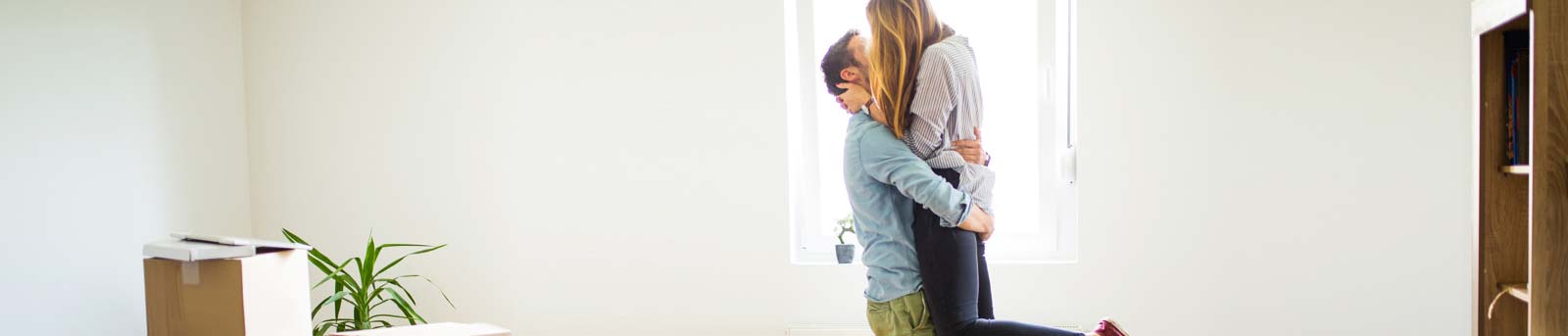 Couple hugging in the lounge room