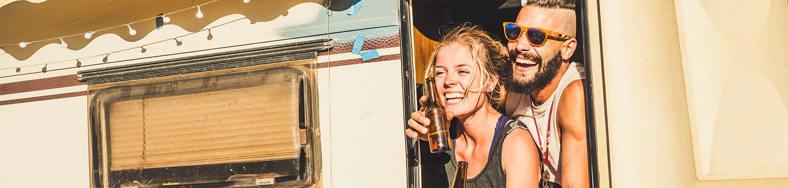 Young couple drinking from caravan