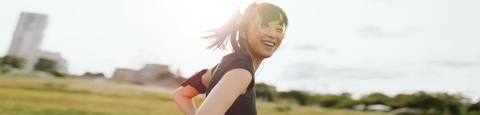 Female runner laughing on field