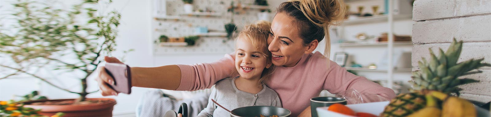 Parent and child eating at home taking a selfie