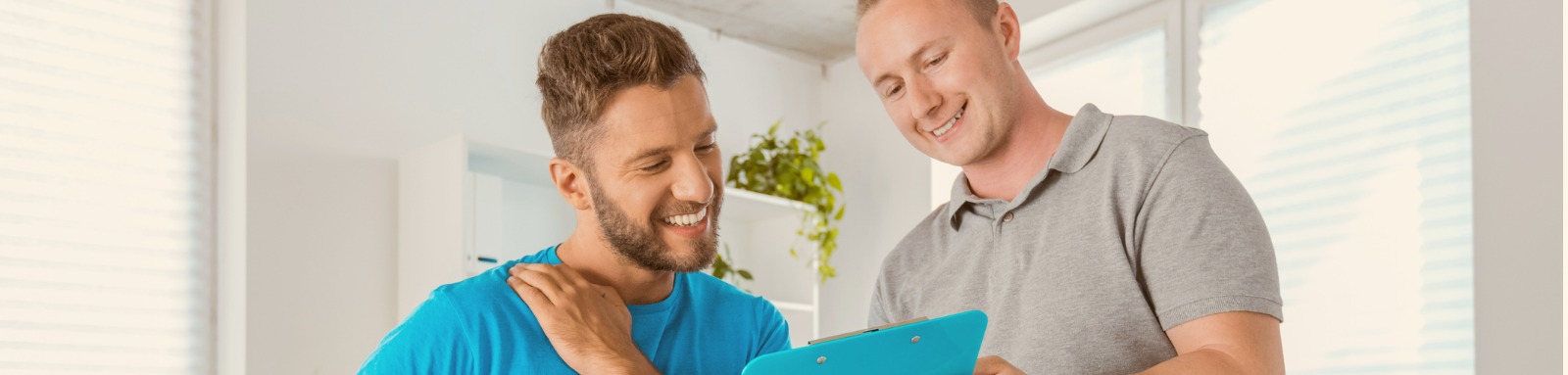 physical therapist talking with young man in rehabilitation center