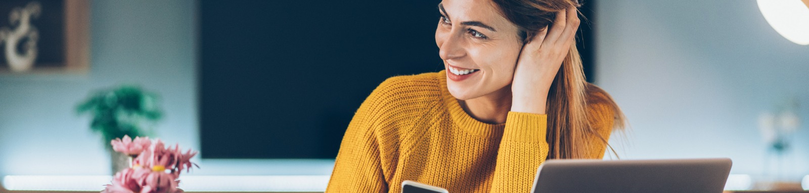 woman at home with computer and phone