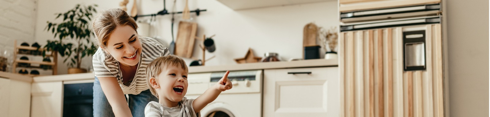 Woman pushing child in washing basket