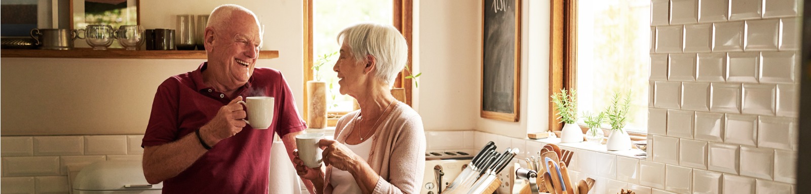 Couple in kitchen drinking tea