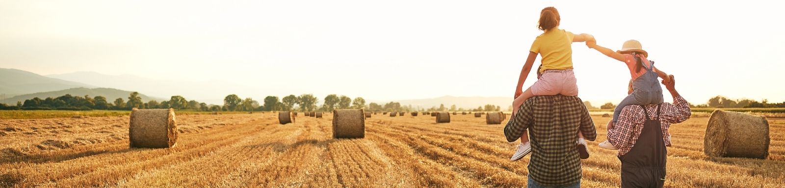 Family walking in hay