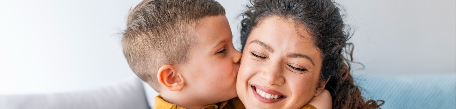 Son kissing mums cheek