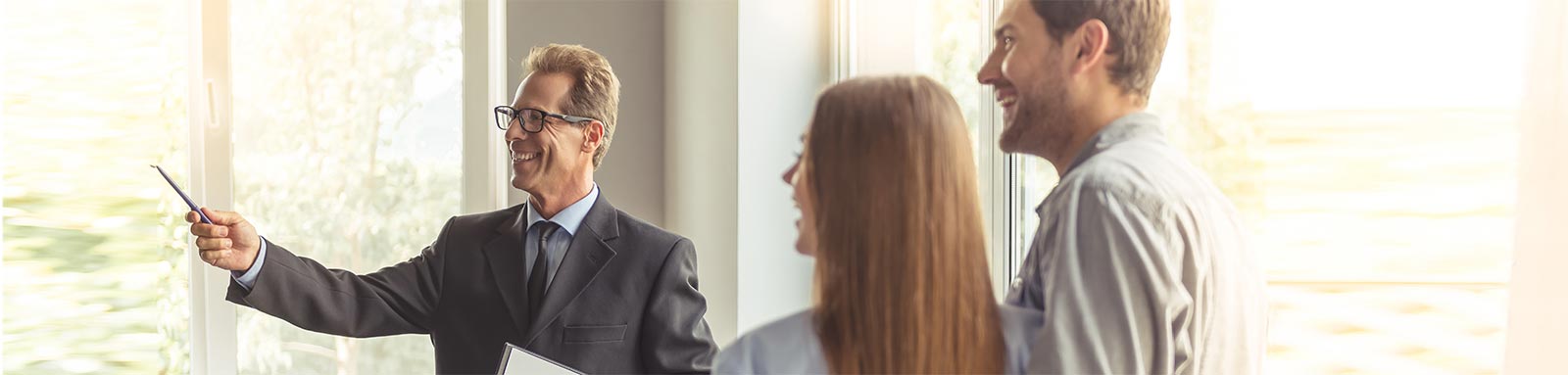 Couple inspecting a house with a realtor