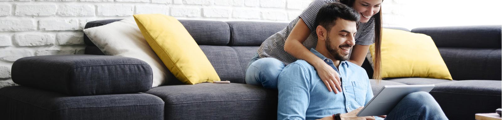 Couple on couch looking at laptop computer