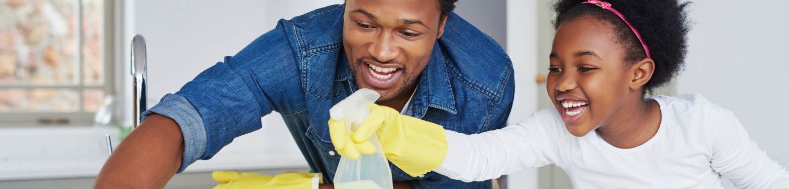 man and young girl cleaning benchtop