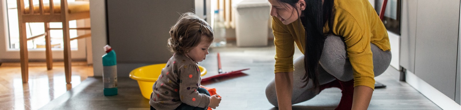 woman and young girl mopping kitchen floor