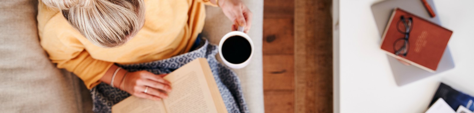 Woman reading a book on a couch