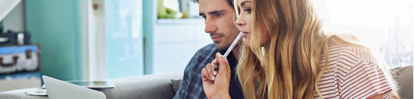 Man and woman concentrating on laptop computer screen