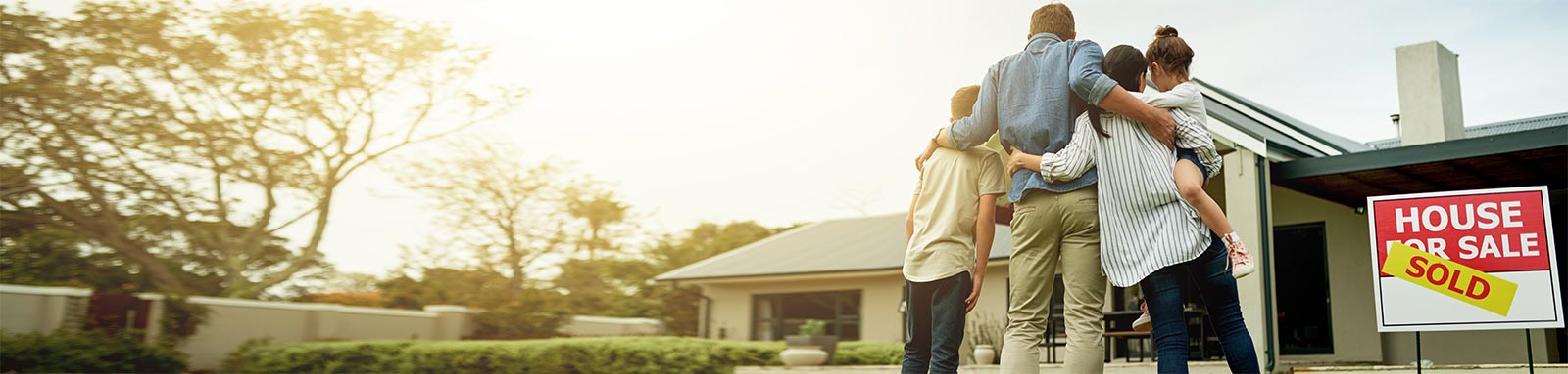 Family posing with newly purchased home