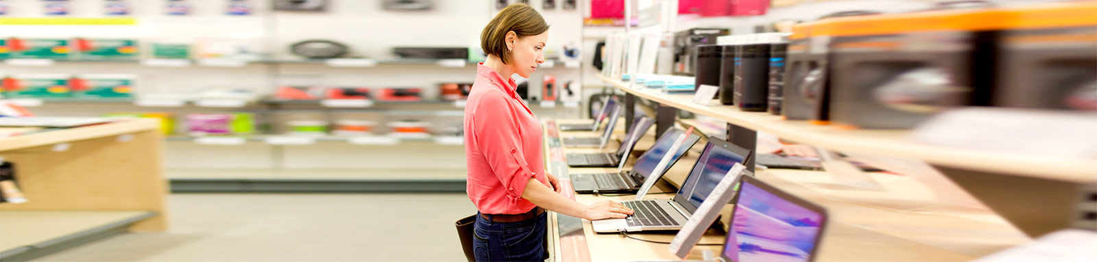 Woman using laptop at a store