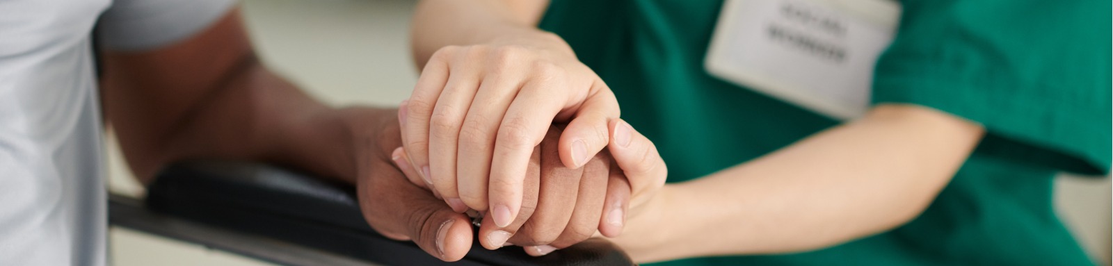 caregiver holding hand of patient