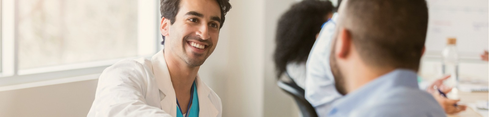 doctor shaking hands with male patient