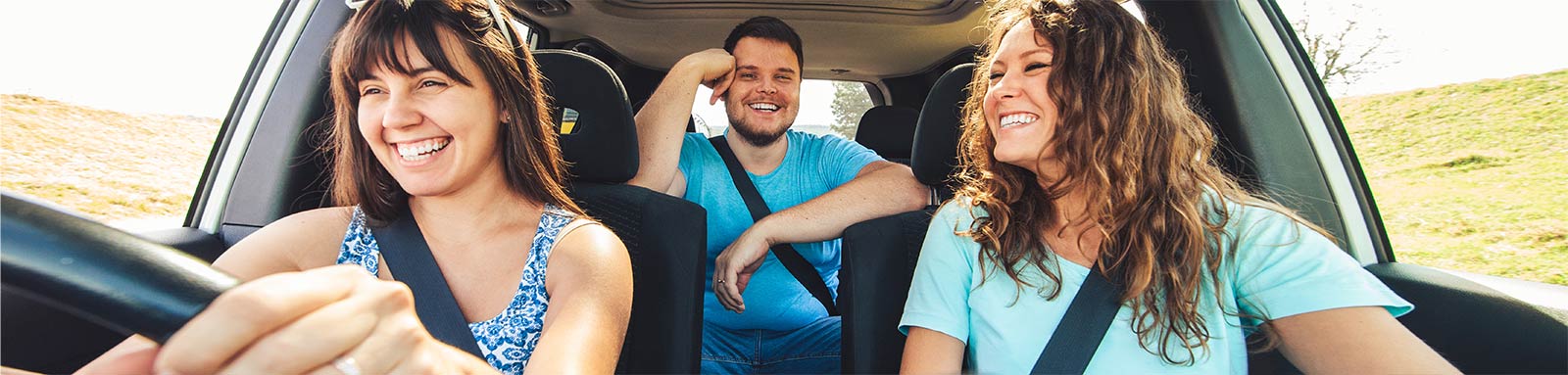 Three friends in a car on a roadtrip