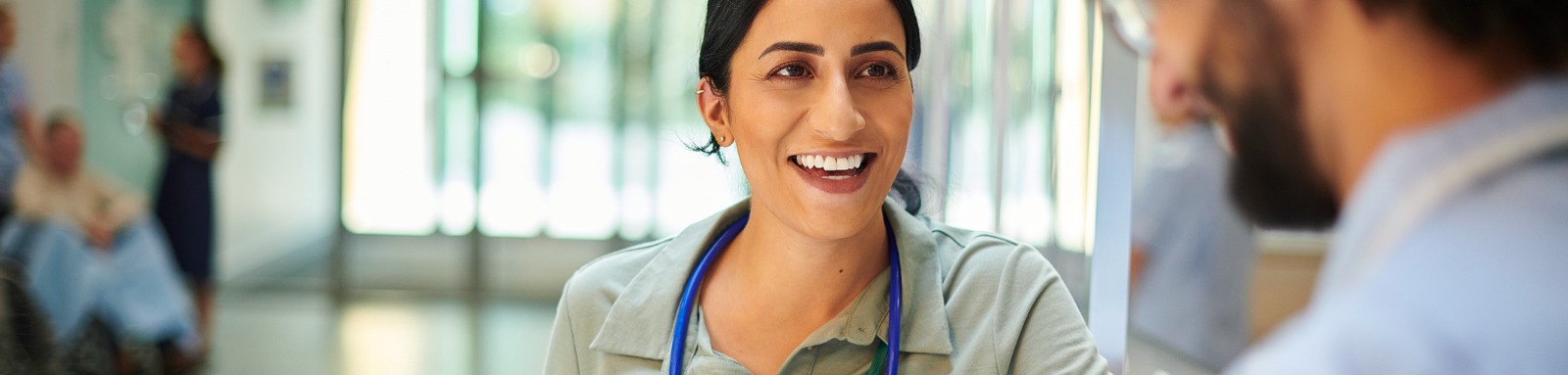 happy hospital doctor chatting to patient