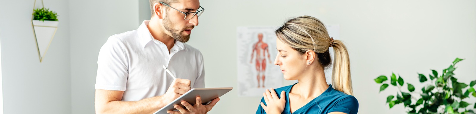 physiotherapist talking to patient about shoulder