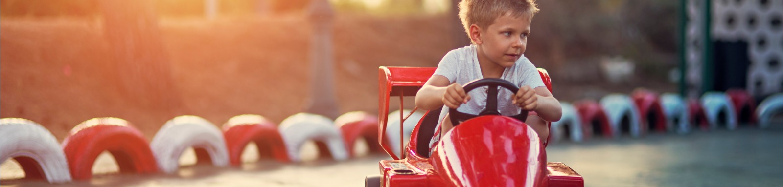 young boy riding bumper car