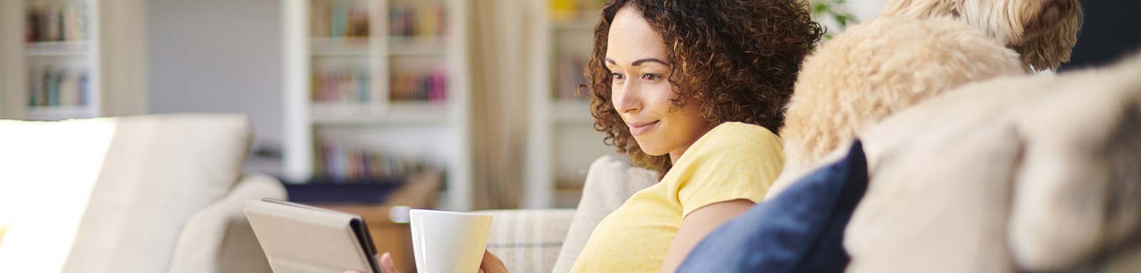 Woman sitting on a couch with a mug