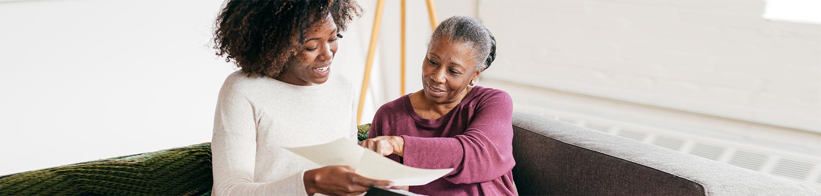 elderly woman speaking with consultant at home