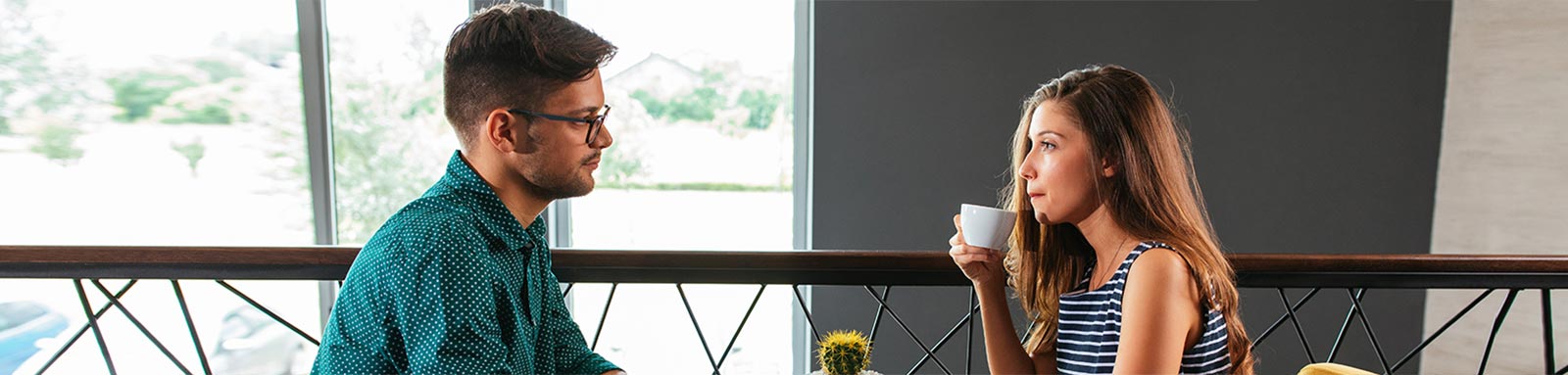 Unhappy couple in cafe drinking coffee