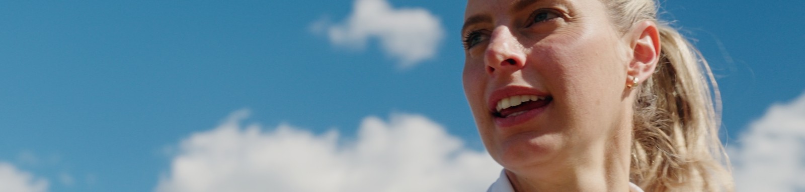 Laura exercising with blue sky in the background
