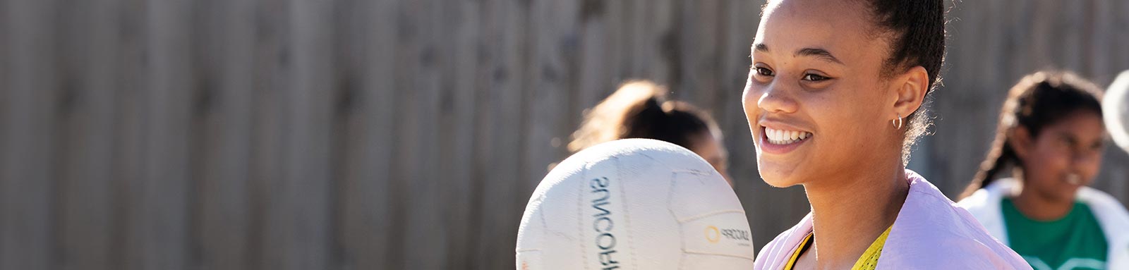 Netball girl holding a netball