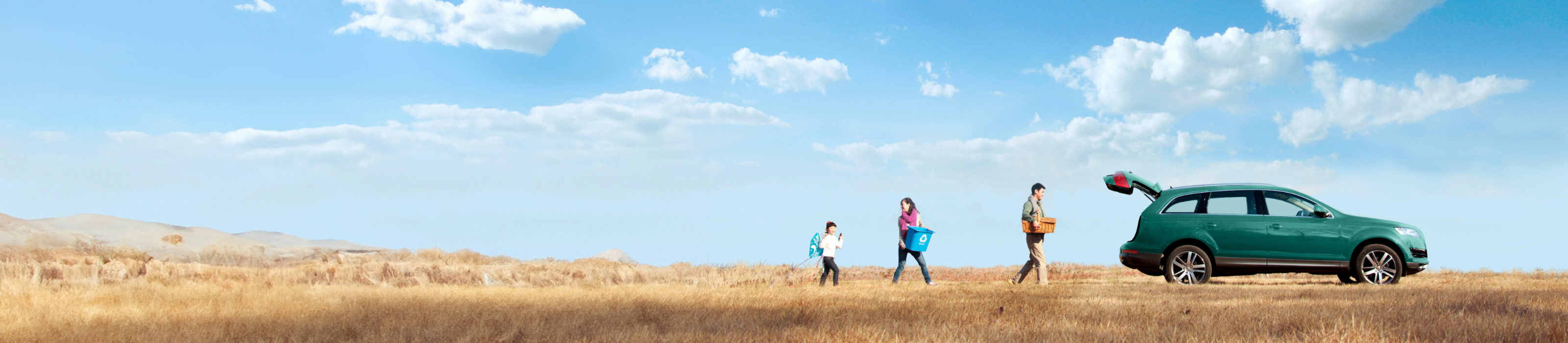 Family walking to car in grasslands