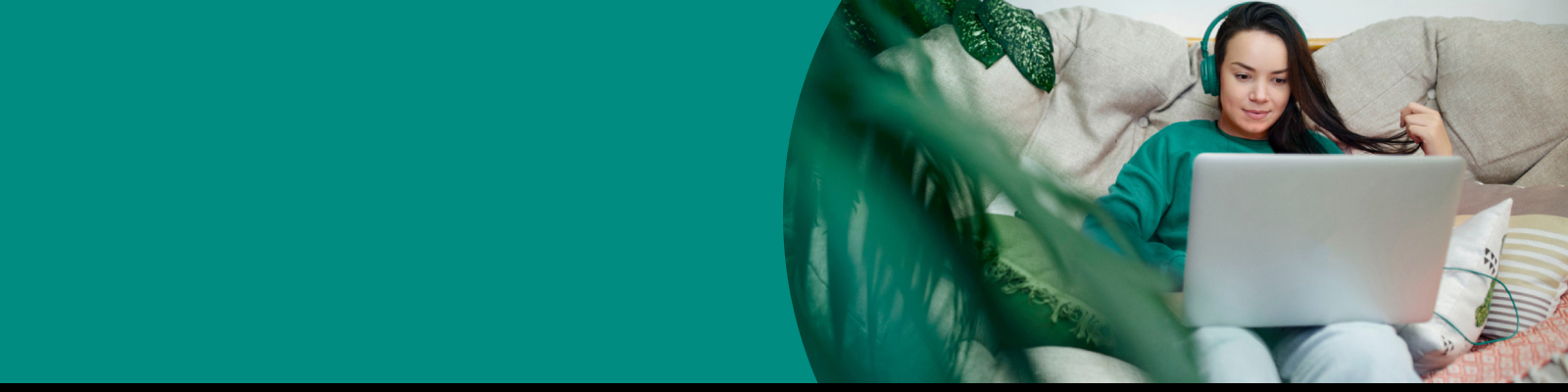 Young woman using laptop while sitting on couch