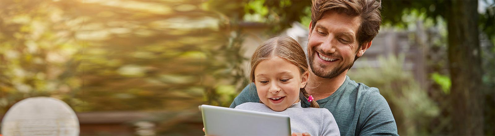 Father and daughter looking at tablet