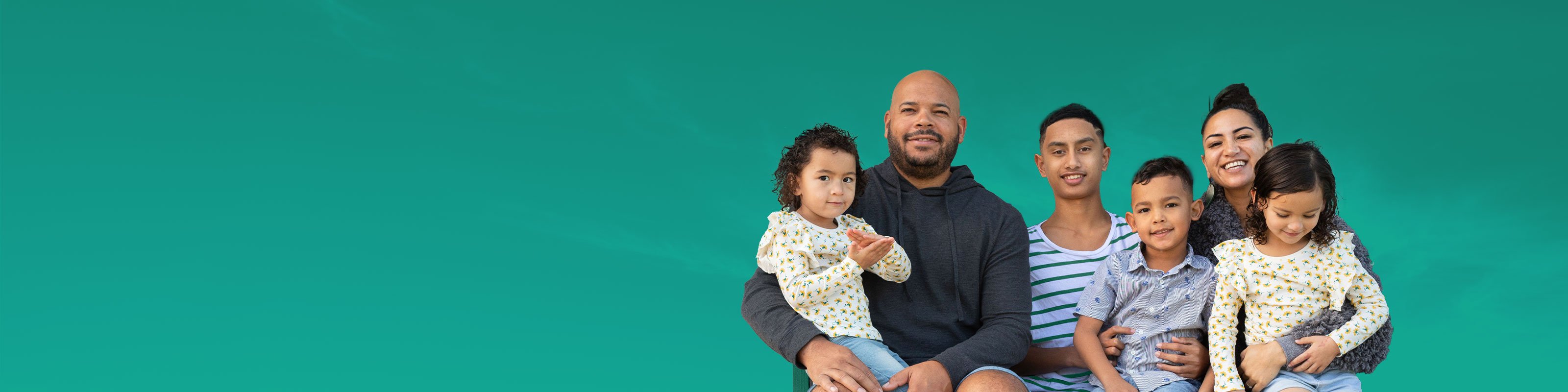 a family of six sitting down with a green background