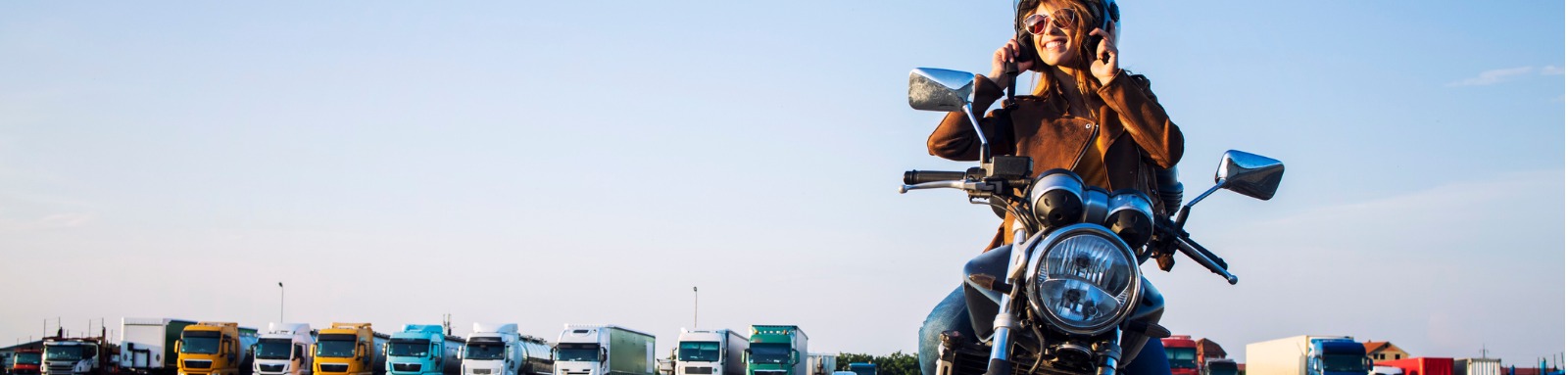 woman-sitting-on-motorbike-wearing-helmet